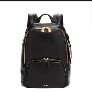 Tumi: Black Backpack with Gold Zippers